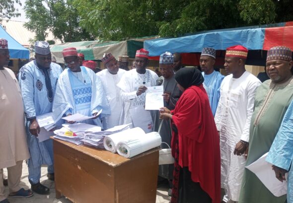 Chairman-of-Gwale-Local-Government-Hon.-Abubakar-Muazu-Mojo-presenting-certificate-of-employment-to-one-of-the-beneficiaries