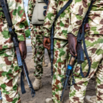 Camouflaged Soldiers with Rifles