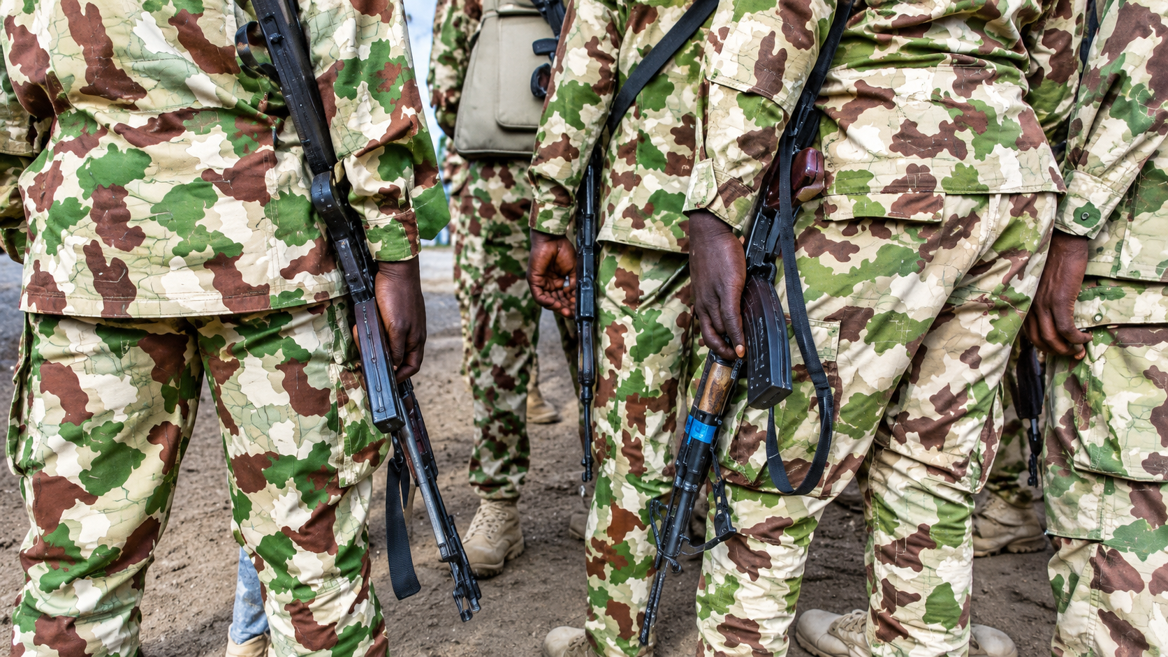 Camouflaged Soldiers with Rifles